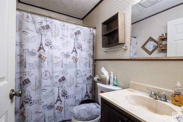 bathroom with toilet, a textured ceiling, walk in shower, and vanity