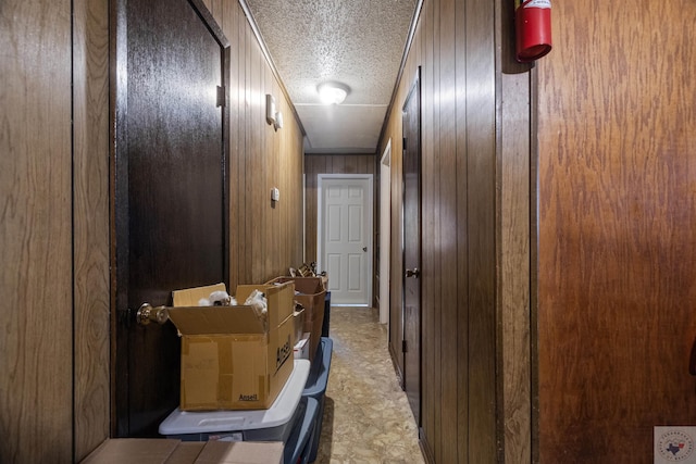 corridor featuring wooden walls