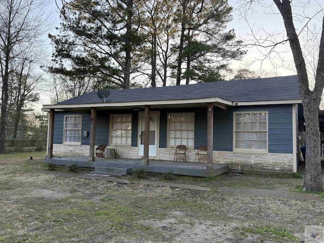 view of front of house with stone siding and covered porch