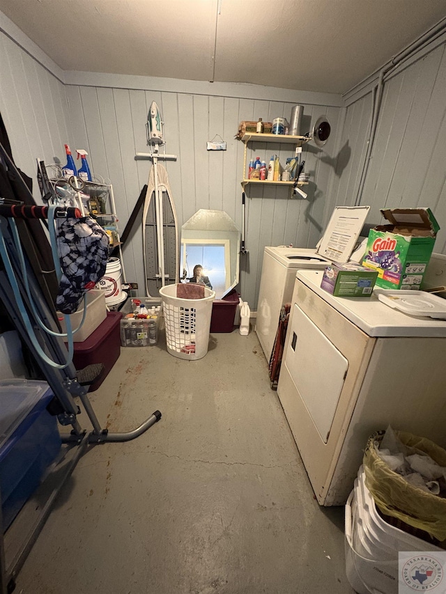 clothes washing area featuring separate washer and dryer and laundry area