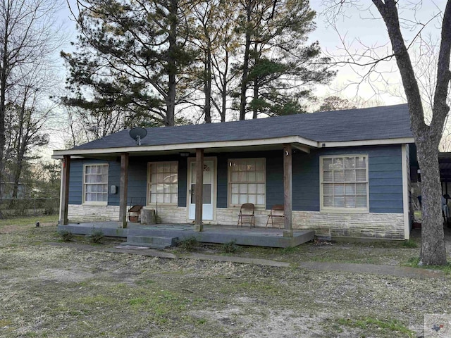 view of front facade with stone siding and covered porch