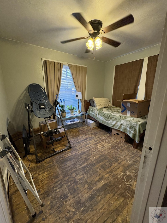 bedroom with ceiling fan and hardwood / wood-style flooring