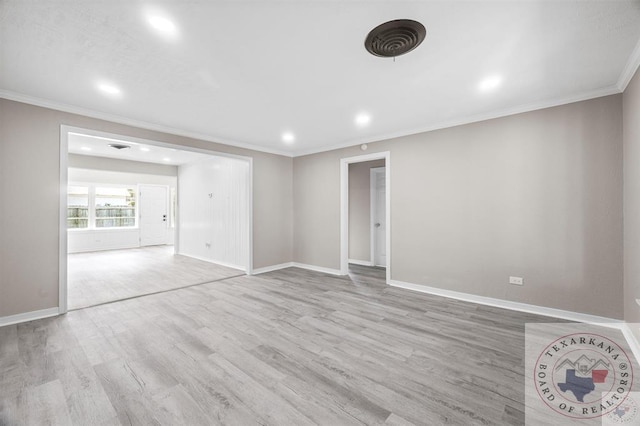 spare room featuring light hardwood / wood-style floors and crown molding