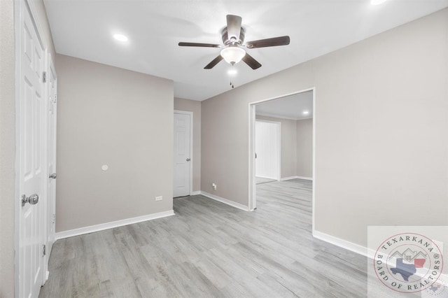 empty room featuring ceiling fan and light hardwood / wood-style floors