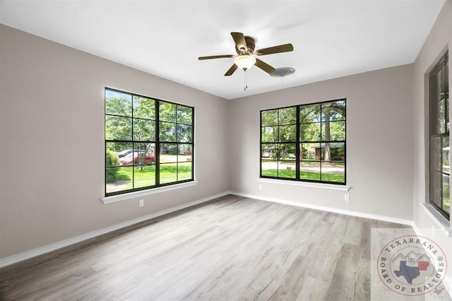 spare room with light hardwood / wood-style floors and ceiling fan