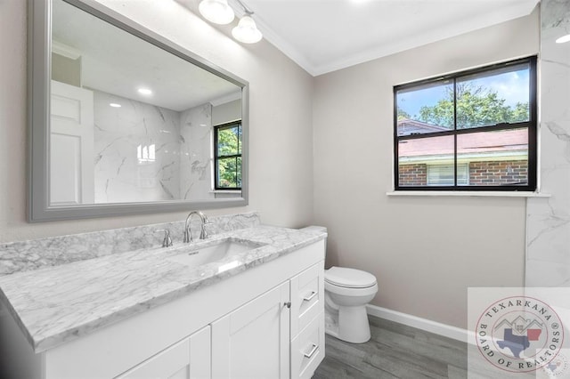 bathroom featuring hardwood / wood-style floors, toilet, vanity, and crown molding