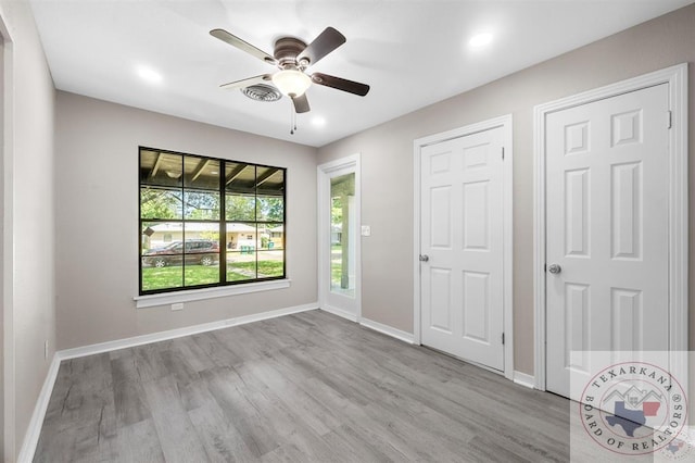 unfurnished bedroom with light wood-type flooring and ceiling fan