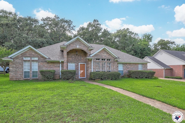 203 Peter Alan St, Wake Village, TX 75501 - view of front of home featuring a front yard, brick siding, and a shingled roof