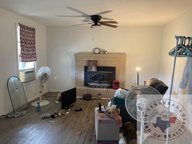 living room with hardwood / wood-style floors, plenty of natural light, cooling unit, and ceiling fan