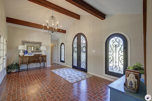 986 Texas Highway 77 W, Atlanta, TX 75551 - entrance foyer with a notable chandelier, baseboards, french doors, arched walkways, and brick floor
