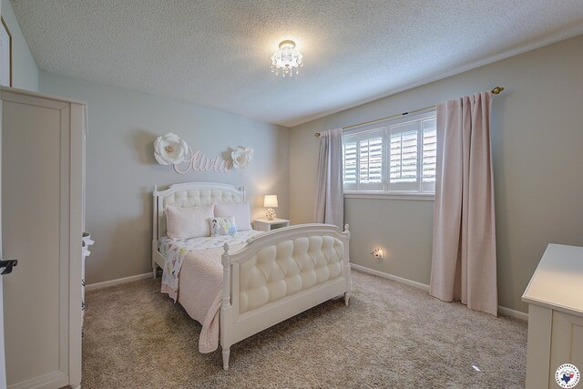 986 Texas Highway 77 W, Atlanta, TX 75551 - bedroom with baseboards, light colored carpet, and a textured ceiling