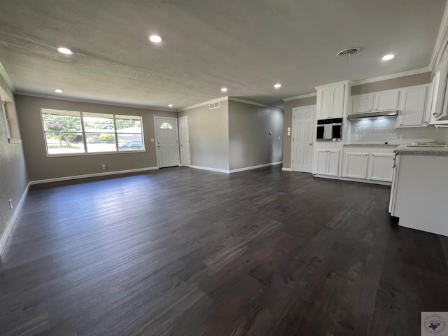 unfurnished living room with sink, dark hardwood / wood-style flooring, and ornamental molding