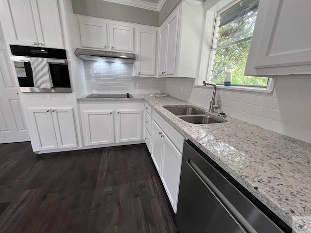 kitchen featuring dark wood-style floors, stainless steel appliances, white cabinets, a sink, and under cabinet range hood