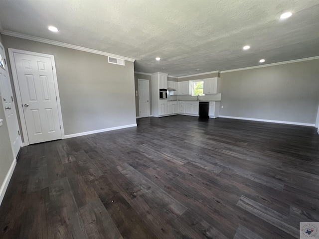 unfurnished living room with sink, a textured ceiling, dark hardwood / wood-style floors, and ornamental molding