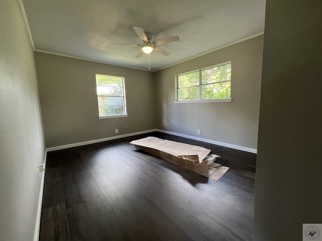 unfurnished room featuring ceiling fan, dark hardwood / wood-style floors, and ornamental molding