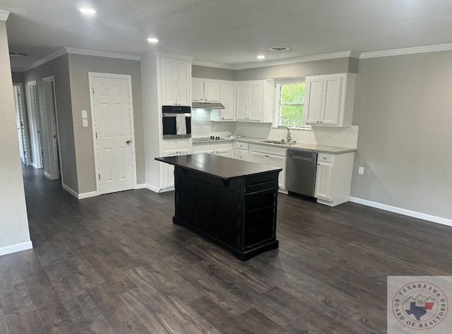 kitchen featuring decorative backsplash, appliances with stainless steel finishes, dark wood-type flooring, white cabinets, and a sink