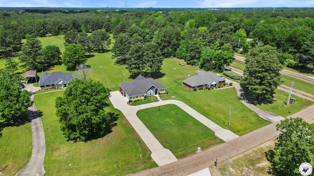 drone / aerial view featuring a wooded view