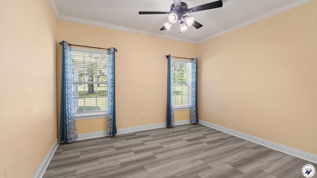 spare room featuring baseboards, a ceiling fan, crown molding, and light wood-type flooring