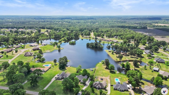 drone / aerial view with a water view, a residential view, and a wooded view