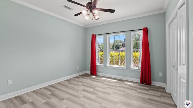 unfurnished room with baseboards, a ceiling fan, crown molding, and visible vents