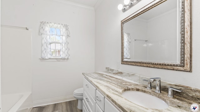 full bath with wood finished floors, toilet, vanity, ornamental molding, and baseboards