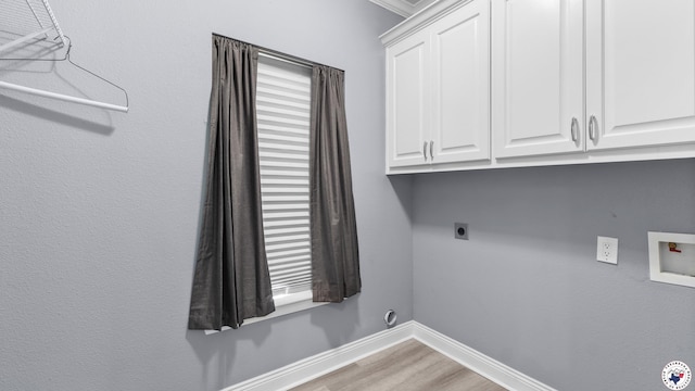 washroom featuring electric dryer hookup, cabinet space, light wood-style flooring, baseboards, and washer hookup