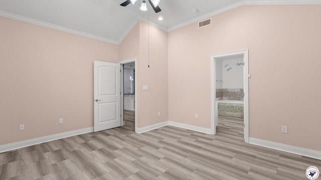 unfurnished bedroom with high vaulted ceiling, wood finished floors, baseboards, ornamental molding, and visible vents