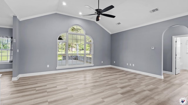 interior space featuring arched walkways, vaulted ceiling, baseboards, visible vents, and a ceiling fan