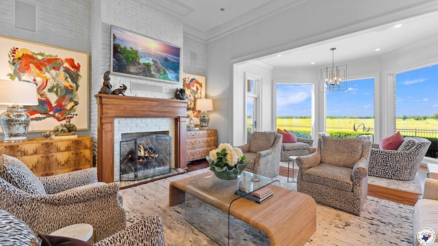 living area featuring recessed lighting, wood finished floors, ornamental molding, a brick fireplace, and a notable chandelier
