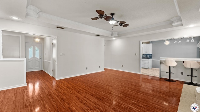 208 Jeffrey Ln, Wake Village, TX 75501 - unfurnished living room featuring crown molding, a raised ceiling, wood finished floors, a ceiling fan, and baseboards