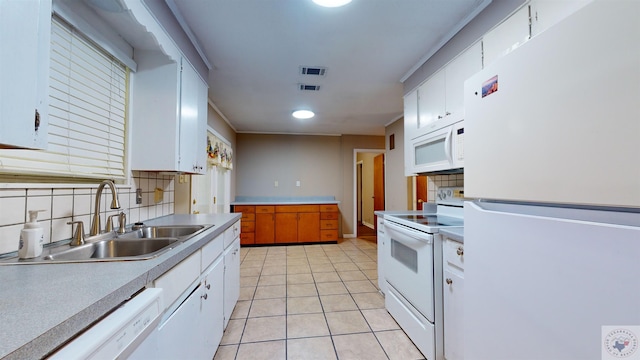 kitchen featuring sink, white appliances, white cabinetry, and tasteful backsplash