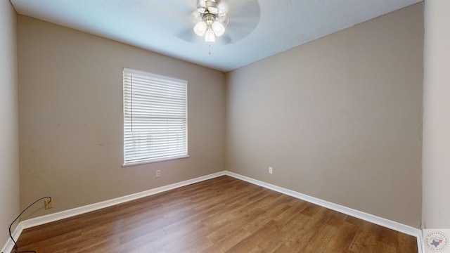 spare room with hardwood / wood-style flooring and ceiling fan