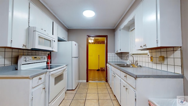 kitchen with sink, white appliances, white cabinets, and tasteful backsplash