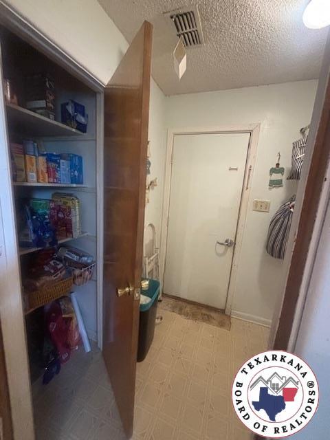 4903 Charleston St, Texarkana, AR 71854 - bathroom with a textured ceiling and tile patterned floors