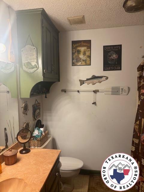 4903 Charleston St, Texarkana, AR 71854 - bathroom featuring vanity and a textured ceiling