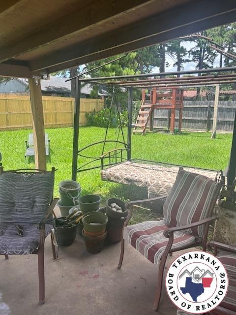 4903 Charleston St, Texarkana, AR 71854 - fenced backyard featuring a patio and a playground