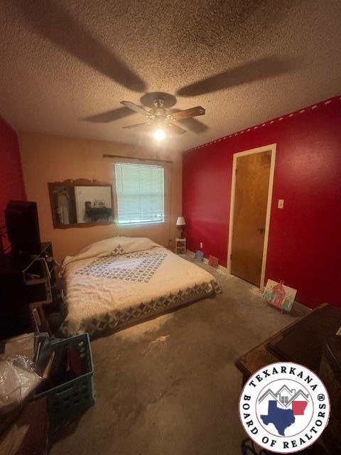 4903 Charleston St, Texarkana, AR 71854 - bedroom with a textured ceiling, a ceiling fan, and carpet flooring