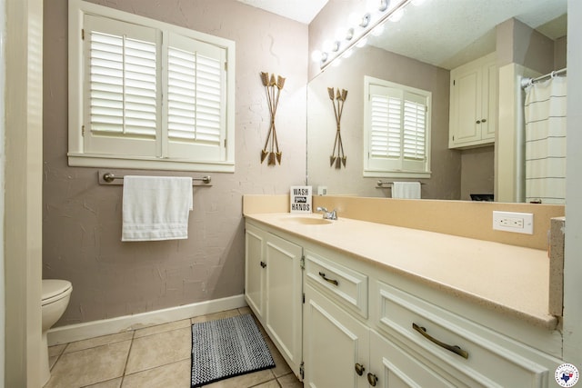 205 S Park Dr, New Boston, TX 75570 - bathroom featuring baseboards, vanity, tile patterned flooring, toilet, and a textured wall
