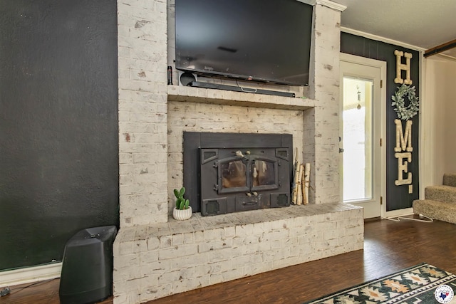 205 S Park Dr, New Boston, TX 75570 - detailed view of wood finished floors, crown molding, and a brick fireplace