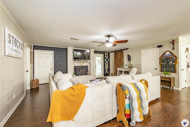 205 S Park Dr, New Boston, TX 75570 - living area featuring ceiling fan, ornamental molding, a barn door, baseboards, and dark wood finished floors