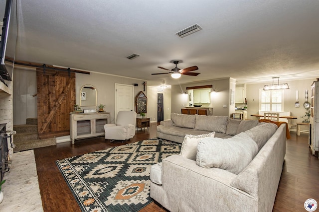 205 S Park Dr, New Boston, TX 75570 - living room with a barn door, ornamental molding, wood finished floors, and a ceiling fan