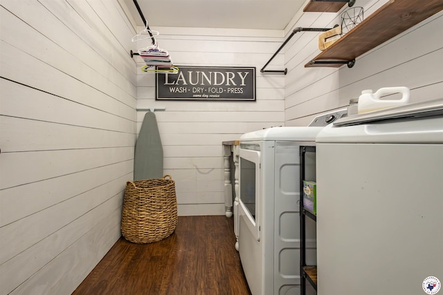 205 S Park Dr, New Boston, TX 75570 - laundry room with washing machine and clothes dryer, dark wood finished floors, and wood walls