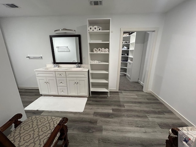 bathroom featuring a sink, visible vents, and wood finished floors