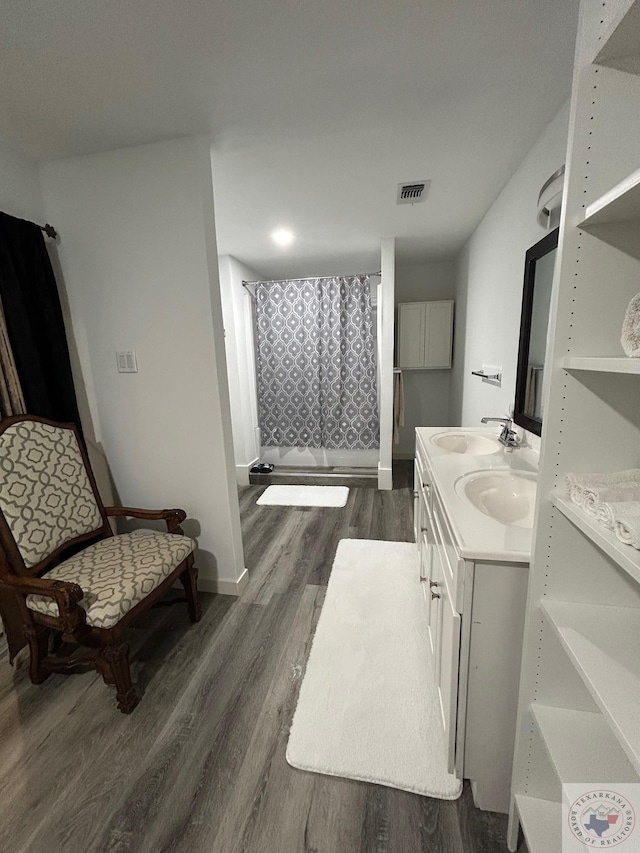 bathroom featuring hardwood / wood-style floors, curtained shower, and vanity