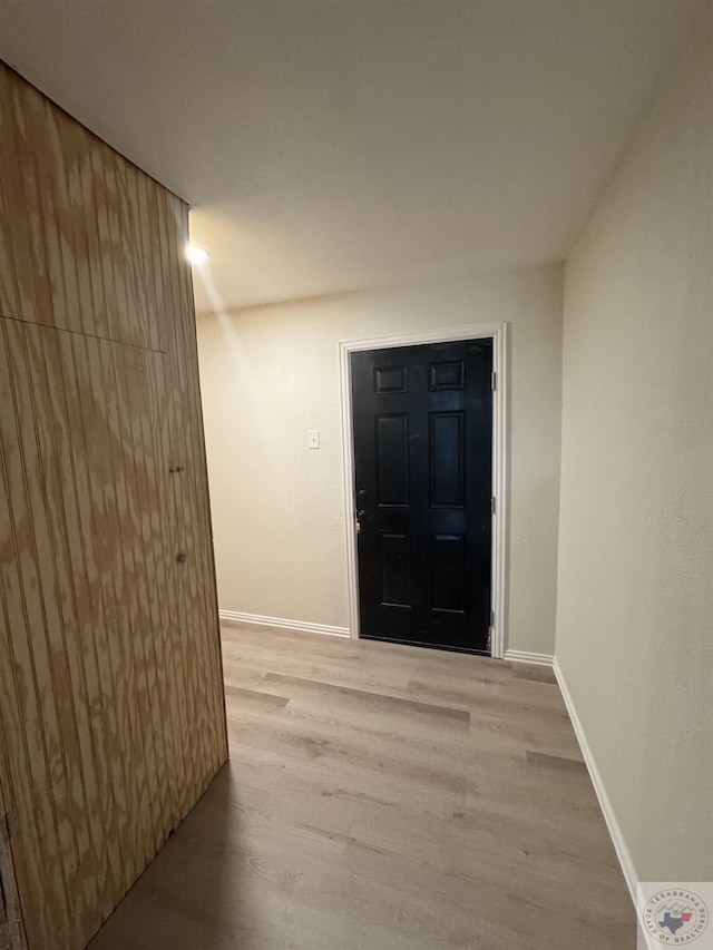 entrance foyer featuring light wood-type flooring and baseboards