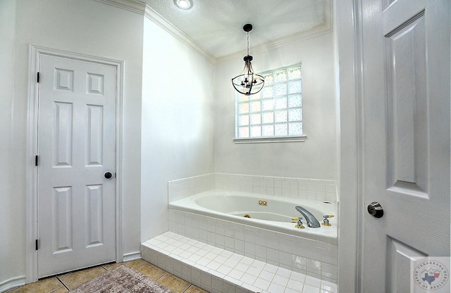 bathroom featuring tiled tub, crown molding, tile patterned floors, and a chandelier