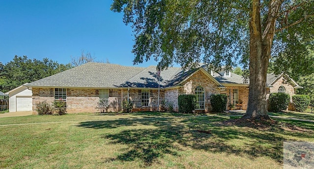 view of front of house with a garage and a front yard