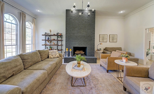 living room featuring crown molding, a brick fireplace, a textured ceiling, and a chandelier