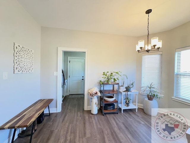 dining area with dark hardwood / wood-style flooring and a chandelier