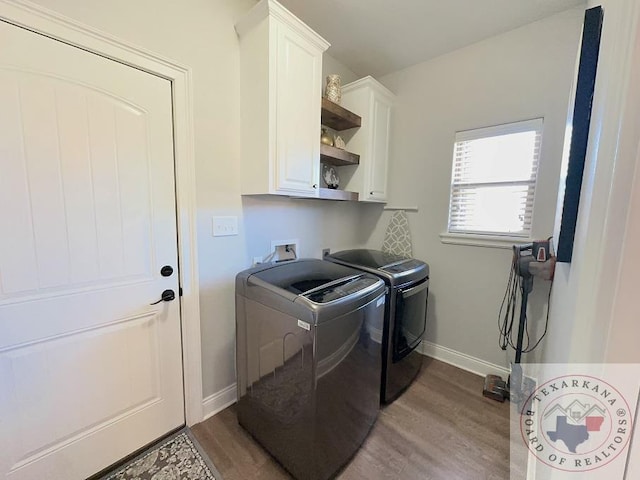 laundry area featuring light wood-type flooring, cabinets, and washer and dryer